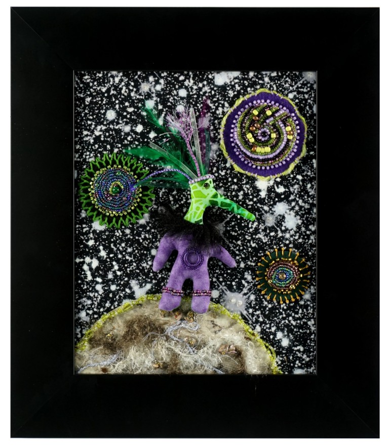 Alien in space with beaded planets. Embroidered textile artwork.