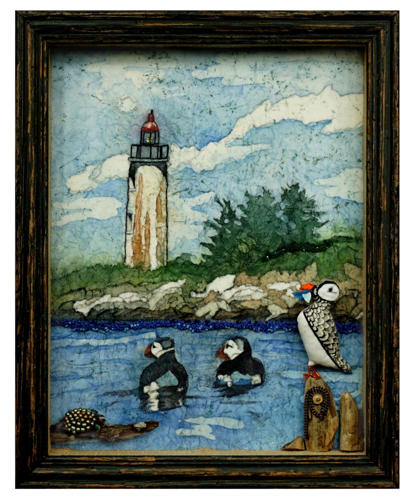 Embroidered painting of puffins and lighthouse in Maine with a beaded turtle.