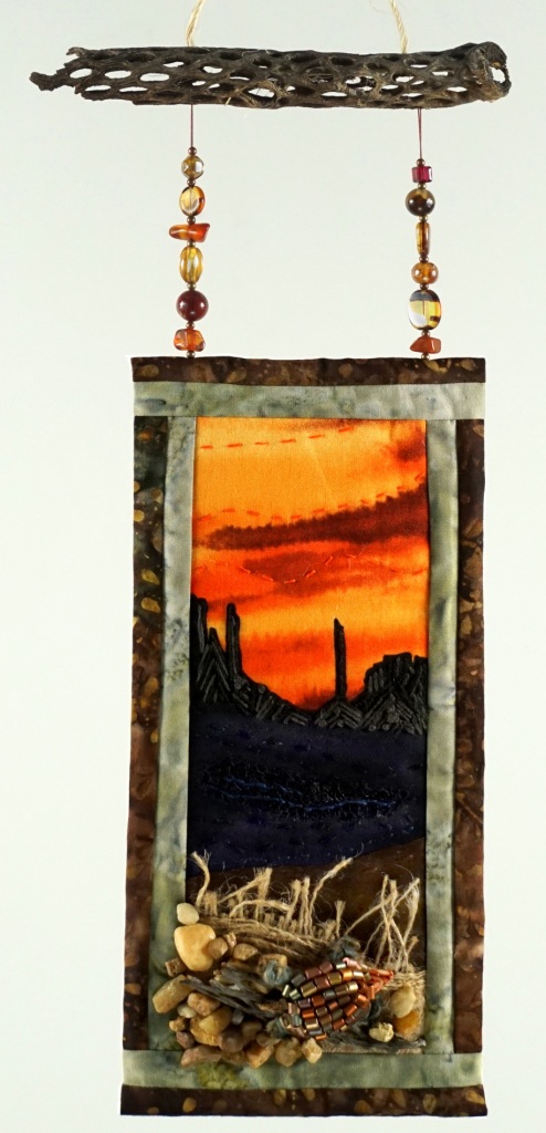 Desert sunset inspired quilted and embroidered textile art work with beaded turtle